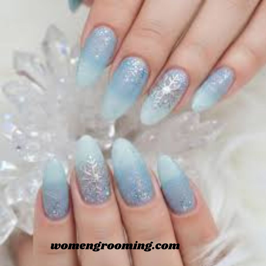 17. Icy Shimmer Blue Nails with Snowflakes