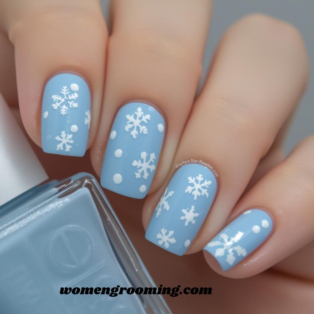 2. Icy Pastel Blue Nails with White Snowflakes