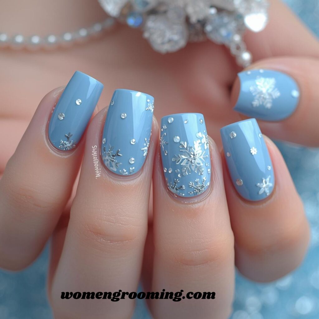 6. Sky Blue Nails with Snowflake Accents